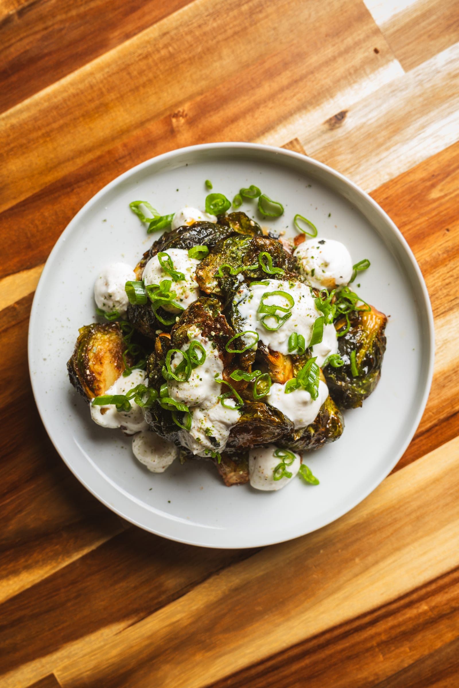 Charred vegetables over whipped tofu with scallion