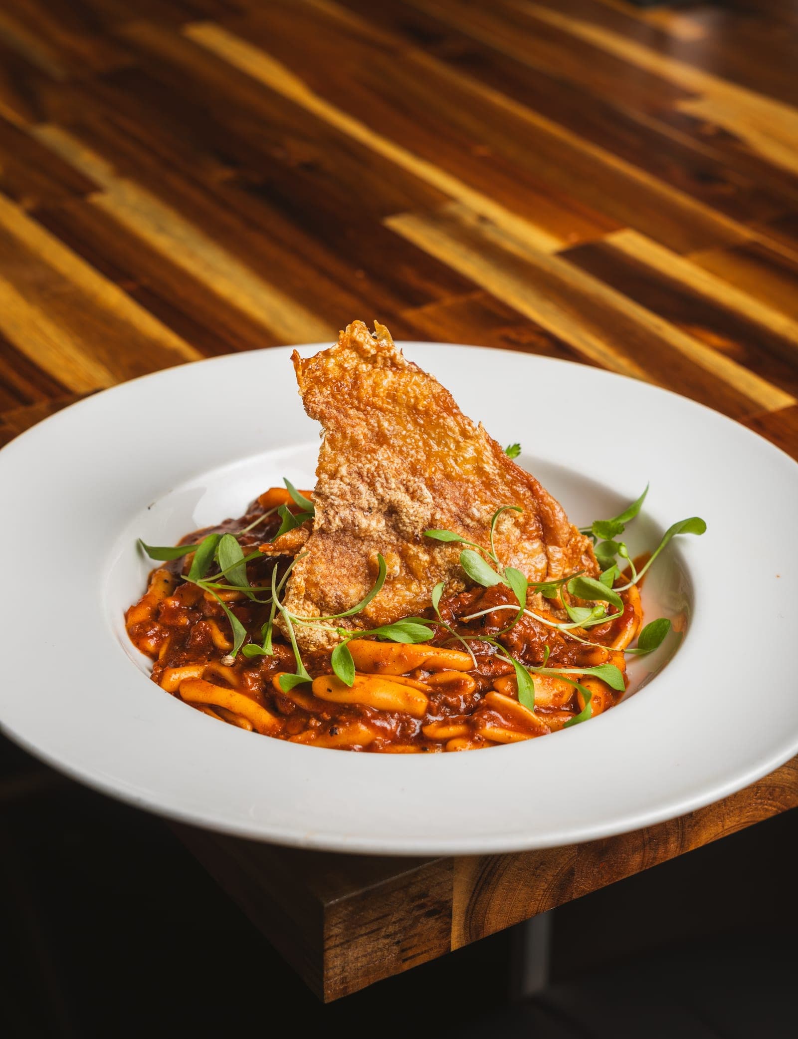 Crispy fish resting in an aromatic broth