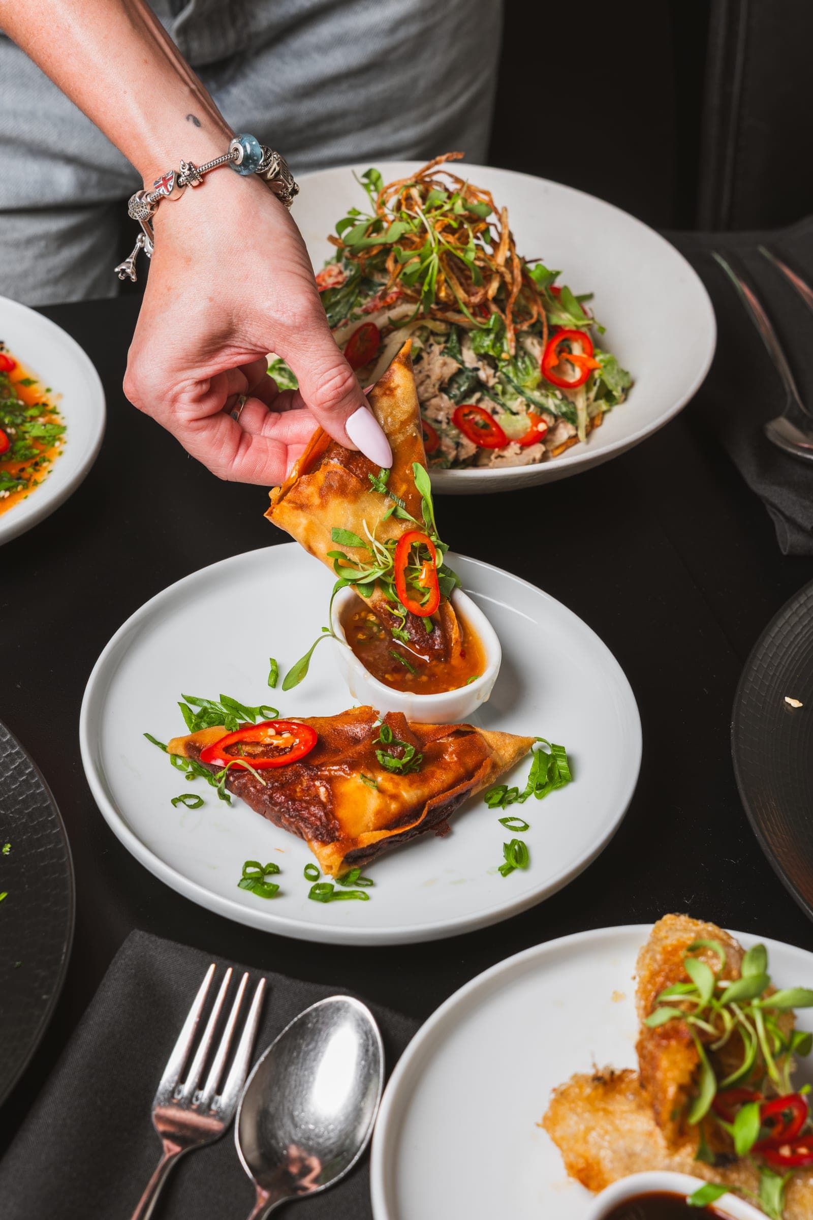 A chef plating a dish in the kitchen
