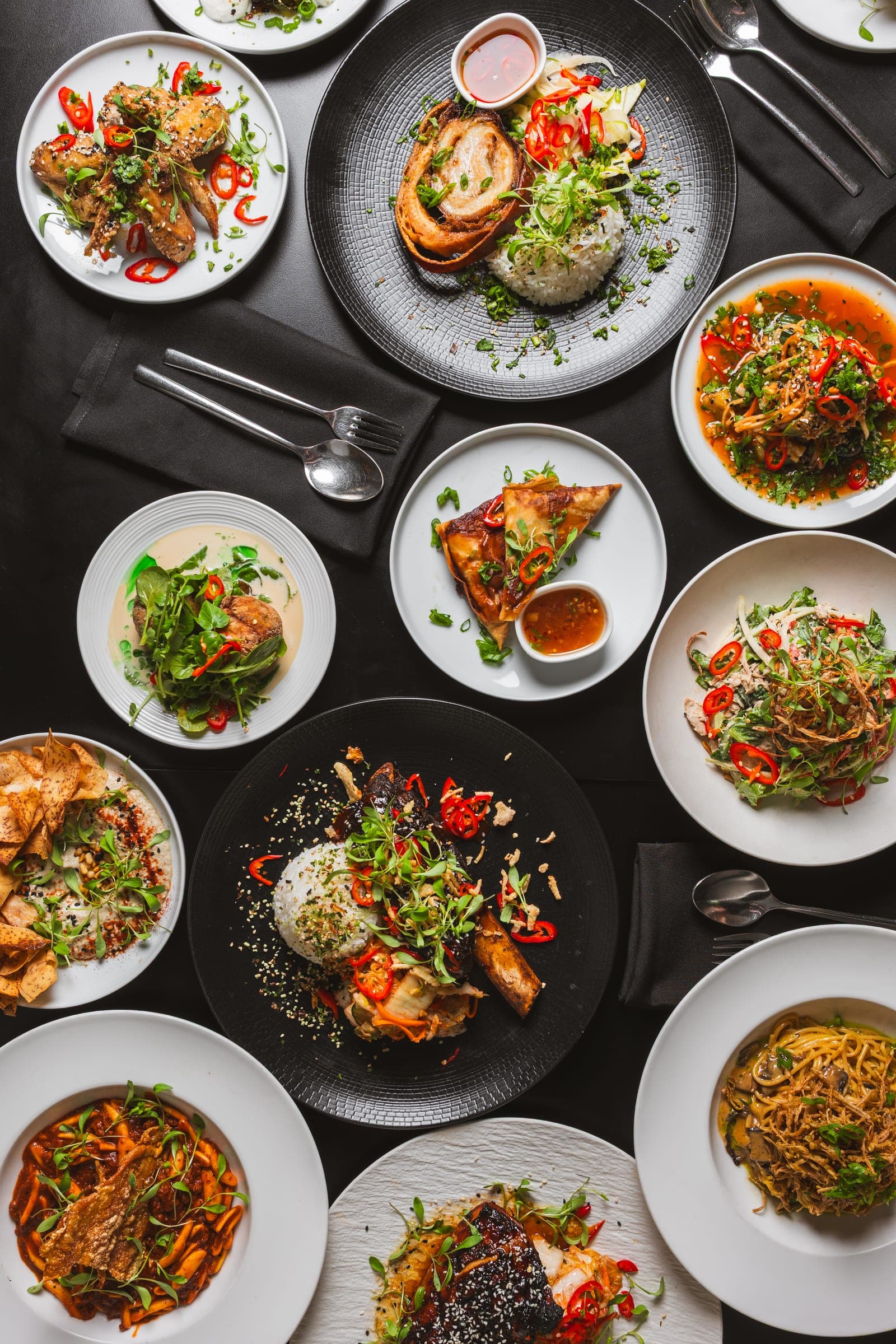 Overhead view of several salads ready to share