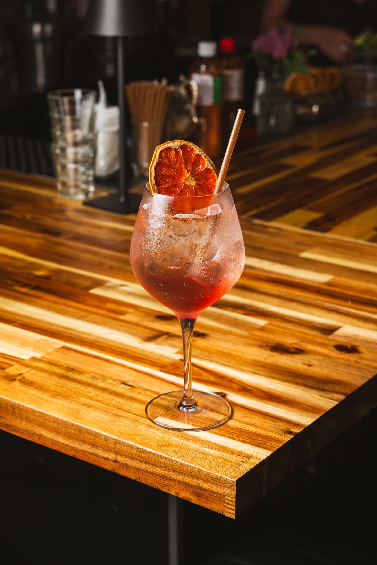 Spritz glowing under warm light on the bar