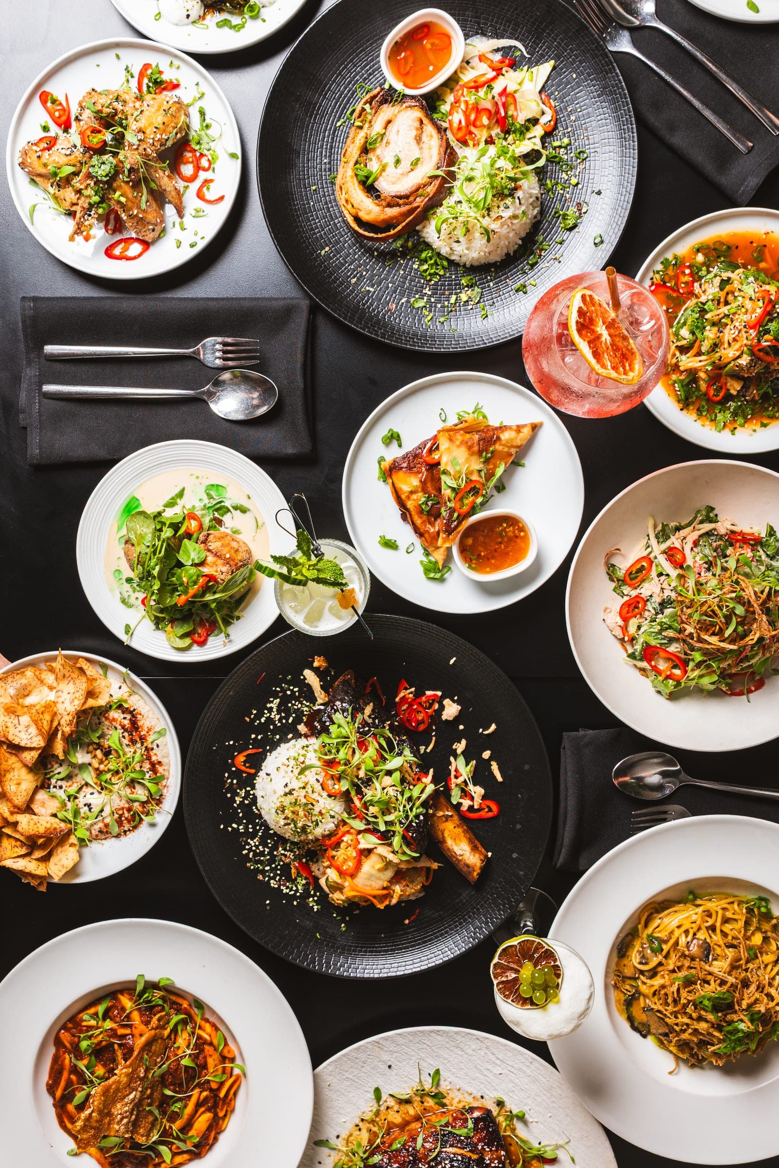 Guests sharing dishes around a full table